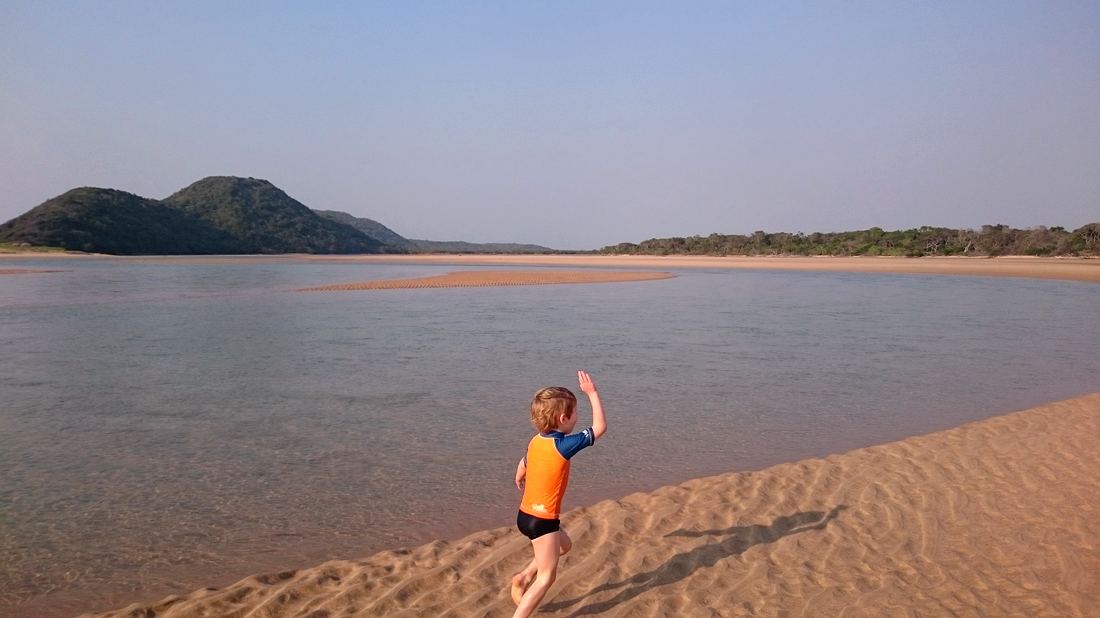Child wading into the Kosi estuary